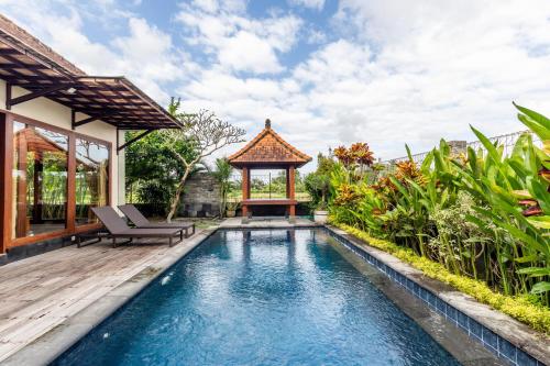 a pool in a backyard with a gazebo at Private Pool Villa - Villa Saia Ubud in Ubud