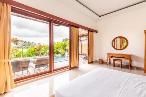 a bedroom with a bed and a large window at Private Pool Villa - Villa Saia Ubud in Ubud