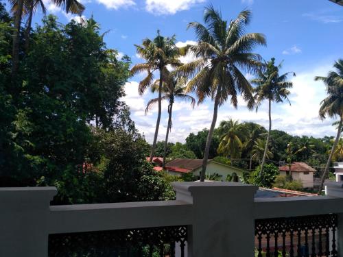 a view from the balcony of a house with palm trees at Ocean Stay in Nedumbassery