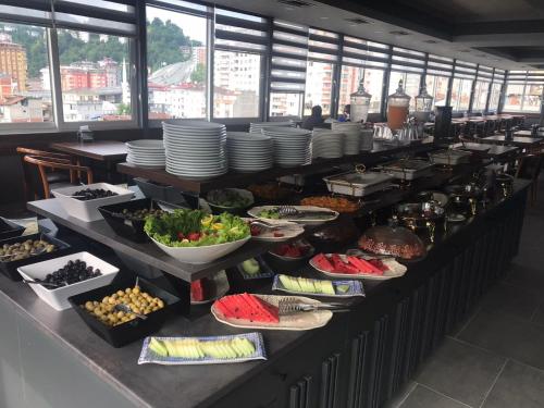 a buffet line with plates and bowls of food at Rhisos Gold Otel in Rize