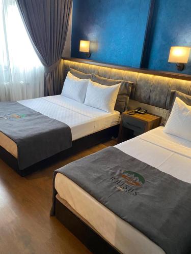 a hotel room with two beds and a couch at Rhisos Gold Otel in Rize