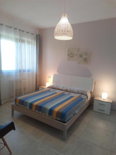 a bedroom with a bed and a chandelier at Villa Anna Maria in Polignano a Mare