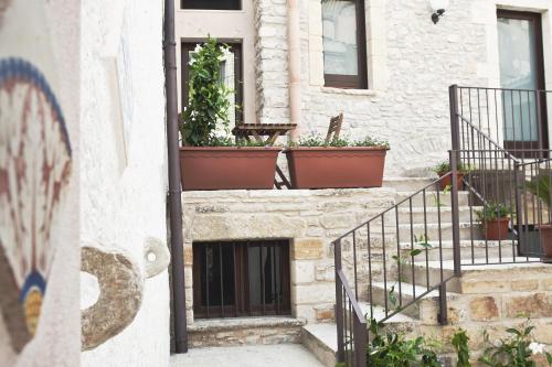a building with potted plants on the side of it at Residence San Martino in Erice