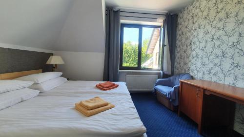 a bedroom with a bed and a desk and a window at ŁOMIANKOWA DOLINA Wetlina 112 in Wetlina