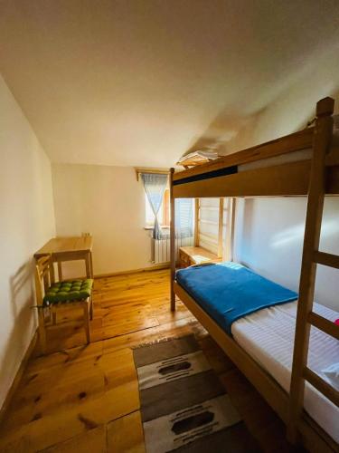 a bedroom with two bunk beds and a chair at Green Training Center in Dzoraghpʼyur