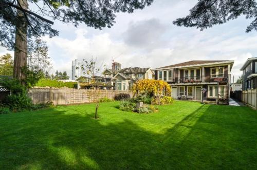 a large house with a yard with a grass yard sidx sidx sidx at Imperial House in Burnaby