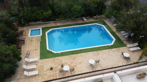 an overhead view of a large swimming pool with chairs at Sylva Hotel in Limassol
