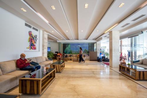 a lobby with couches and tables in a building at Mourya Hotel in Bhairāhawā