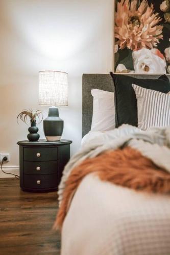 a bedroom with a bed and a table with a lamp at Olinda Nature Sunset Apartment in Olinda