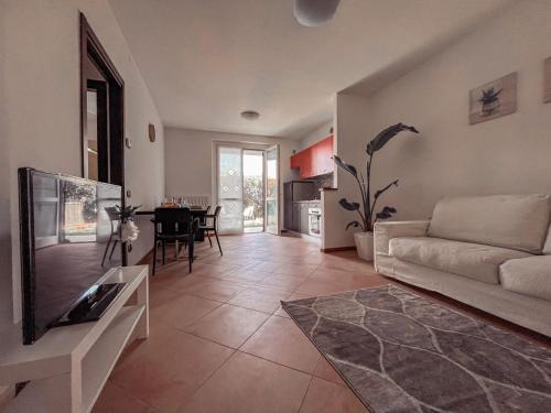 a living room with a couch and a tv at Appartamento Incantevole a 100metri dal mare e accanto alla Pista Ciclabile in Imperia