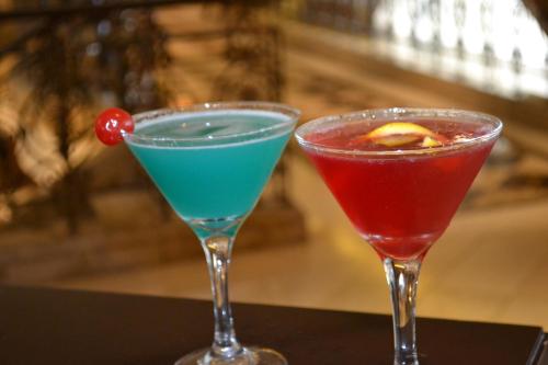 two cocktails sitting next to each other on a table at Sheraton Khalidiya Hotel in Abu Dhabi