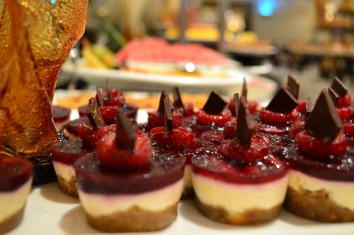 a group of cupcakes with strawberries on top of them at Sheraton Khalidiya Hotel in Abu Dhabi