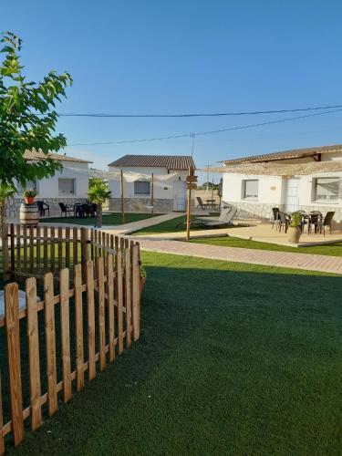 a wooden fence in front of a yard at ALAMANCHA in Casas de los Pinos