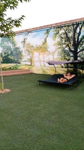 a person laying on a hammock under a table at ALAMANCHA in Casas de los Pinos