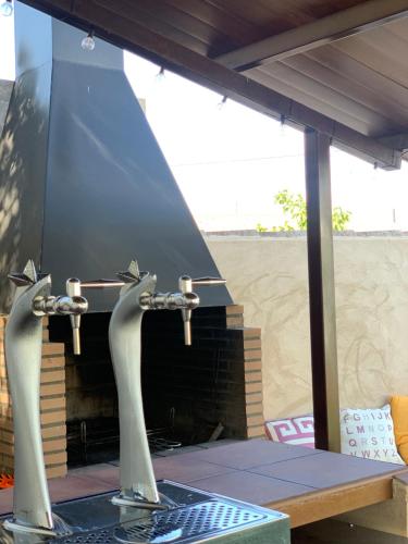 an outdoor grill with a table with a stove at ALAMANCHA in Casas de los Pinos