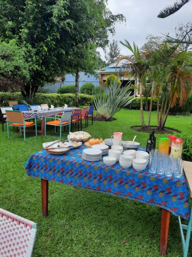 a table with plates of food and drinks on it at Isange Paradise Resort in Ruhengeri