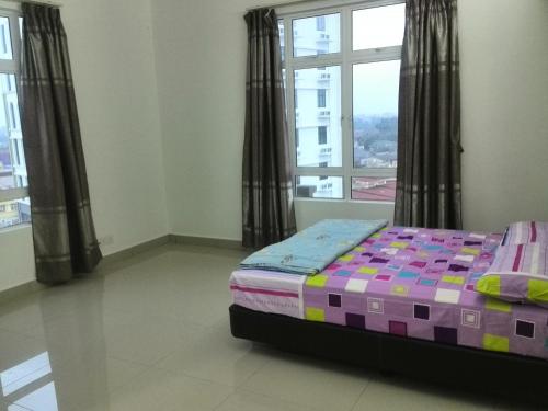 a bedroom with a bed and a large window at Homestay SA De' Viana Apartment in Kota Bharu