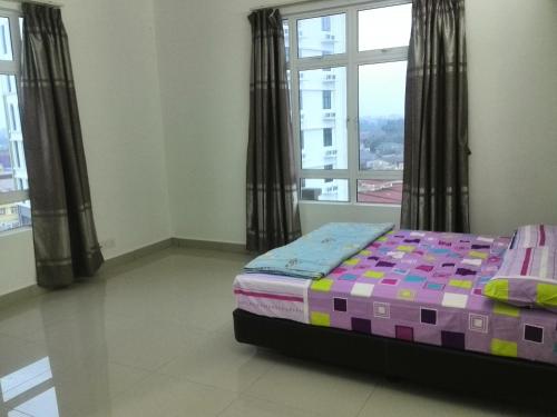 a bedroom with a bed and a large window at Apartment Homestay SA in Kota Bharu