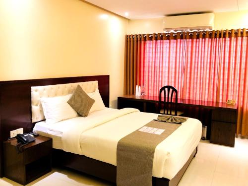Richmond Hotel Sylhetにあるベッド