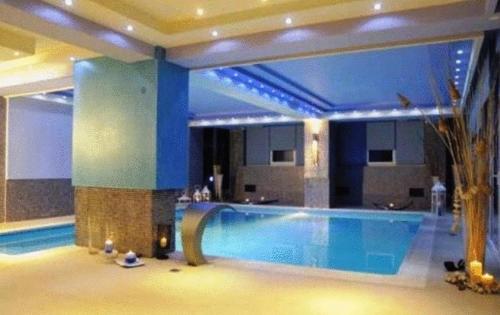 a large swimming pool in a large building at Phaidon Hotel & Spa in Florina