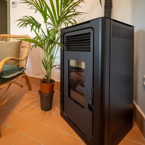 a television sitting on a floor next to a plant at Apartamento para pareja, Finca Contrabando. Sanlucar del Guadiana in Sanlúcar de Guadiana