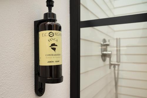 a bottle of wine is hanging on a door at Apartamento para pareja, Finca Contrabando. Sanlucar del Guadiana in Sanlúcar de Guadiana