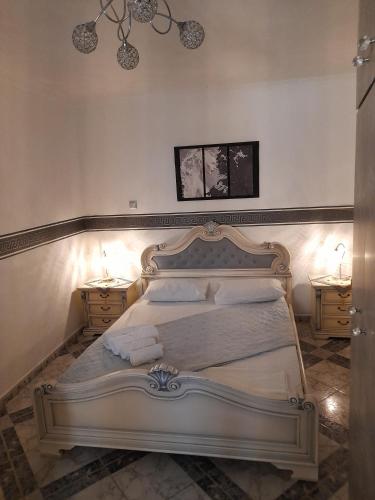 a bedroom with a white bed with two night stands at Villa Markos in Perissa