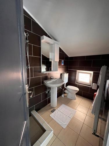 a bathroom with a sink and a toilet at Hotel Begić in Sarajevo