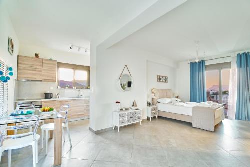 a kitchen and living room with a bed and a table at Lydia's Apartments in Kissamos