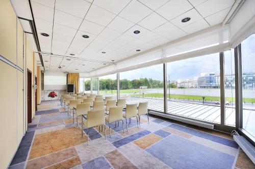 a conference room with chairs and large windows at Sofitel Warsaw Victoria in Warsaw