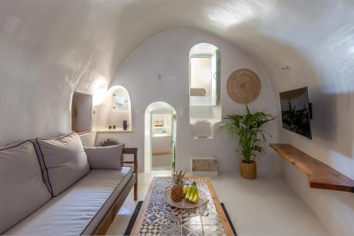 a living room with a couch and a table at Exi Castle Suites in Emporio Santorini