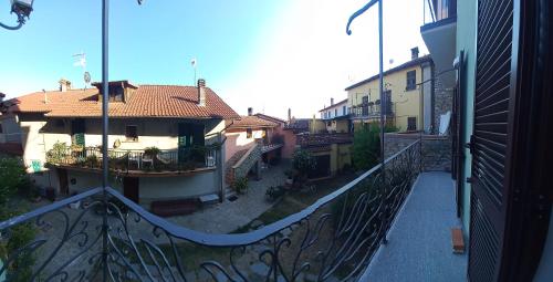 a balcony with a view of a city with buildings at La maison du château in Cremolino