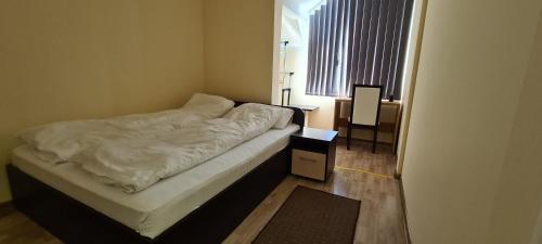 a small bed in a room with a window at Villa Ducic in Zlatibor