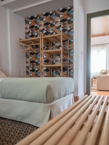 a bedroom with a wall of wine bottles at Apartamento para pareja, Finca Contrabando. Sanlucar del Guadiana in Sanlúcar de Guadiana