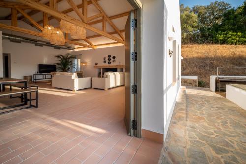 a patio with a wooden floor and a dining room at Apartamento para pareja, Finca Contrabando. Sanlucar del Guadiana in Sanlúcar de Guadiana