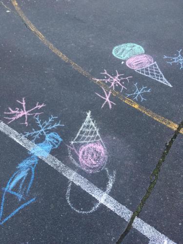 a sidewalk with chalk drawings on the street at Stay in School by the Sea in Dunedin