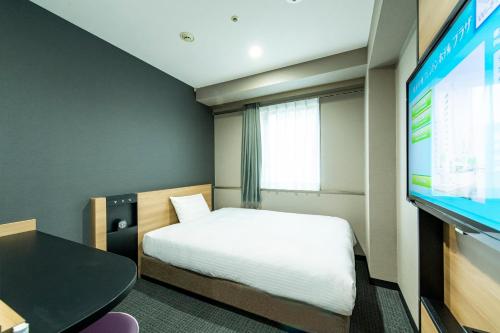 Tempat tidur dalam kamar di Hakata Nakasu Washington Hotel Plaza