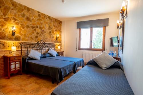 Postel nebo postele na pokoji v ubytování Hostal El Guerrer