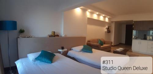 Ένα ή περισσότερα κρεβάτια σε δωμάτιο στο Alia Beach Residence