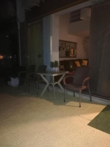a table and chairs in a living room at night at Penelope -Πηνελόπη in Loutra Edipsou