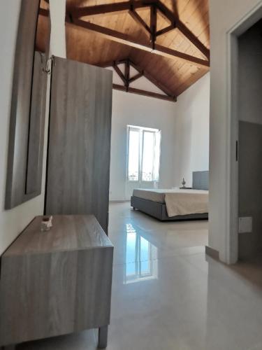 a large white room with a bed and a table at Antica Masseria Malvezzi in Matera
