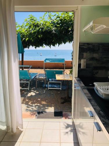 an open door to a patio with a view of the ocean at Résidence Villa Nova in Tiuccia