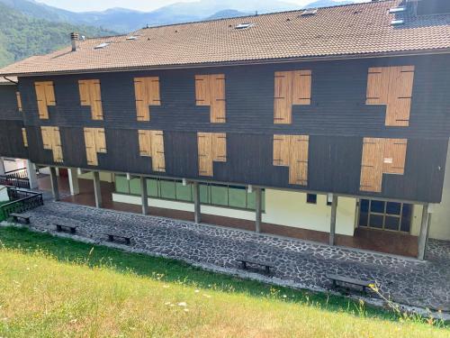 a building with wooden doors on the side of it at Casa GaEl in Fiumalbo