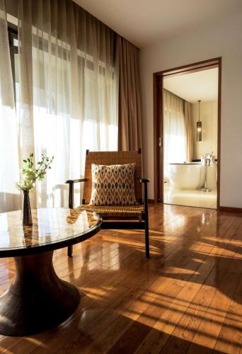 a living room with a couch and a table and a tub at Alila Diwa Goa - A Hyatt Brand in Majorda