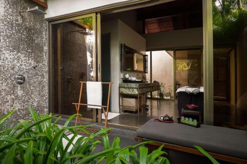 a room with a bed and a desk in a house at Alila Diwa Goa - A Hyatt Brand in Majorda