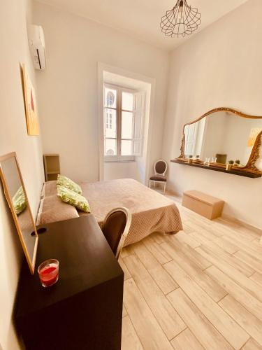 a bedroom with a bed and a mirror on the wall at Cupola San Marcellino in Naples