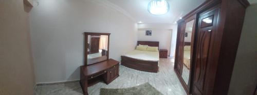 a bedroom with a bed and a dresser and a mirror at Sea spirit in Alexandria