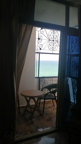 a table and chair in a room with a window at Sea spirit in Alexandria