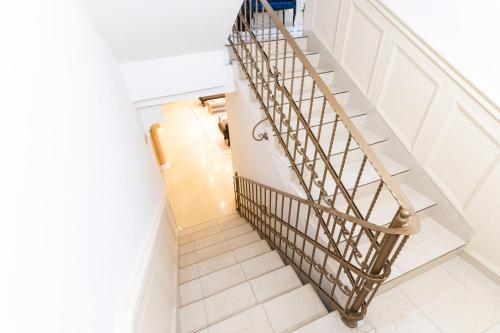 a staircase in a house with a metal railing at Villa Lilith Smart in Fertőrákos