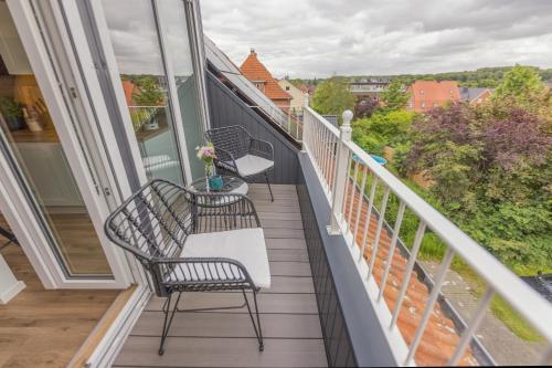 a balcony with two chairs and a table at Loft mit Burgblick in Bad Bentheim